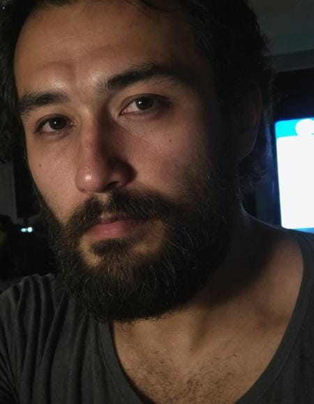 AI-generated portrait of a bearded person with realistic lighting